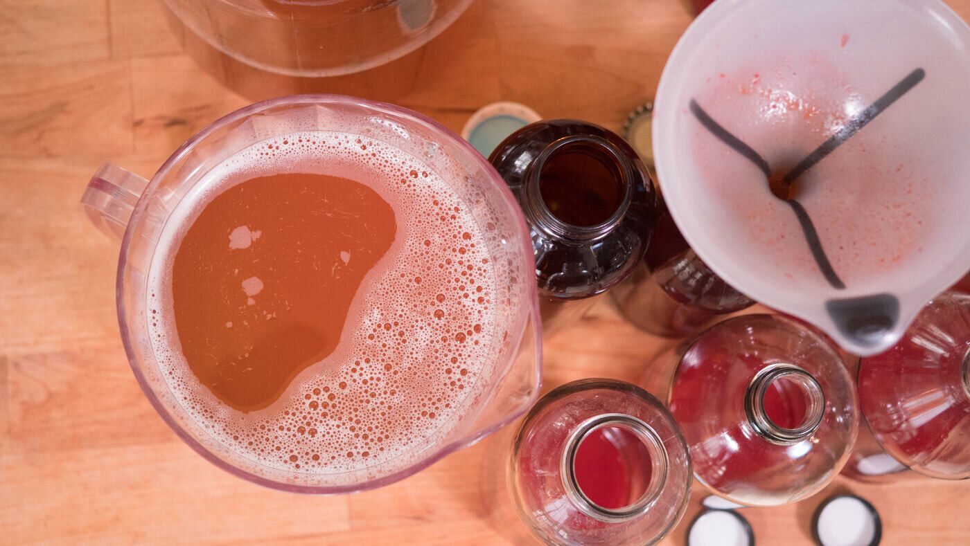 Pouring a fresh glass of home-brewed kombucha